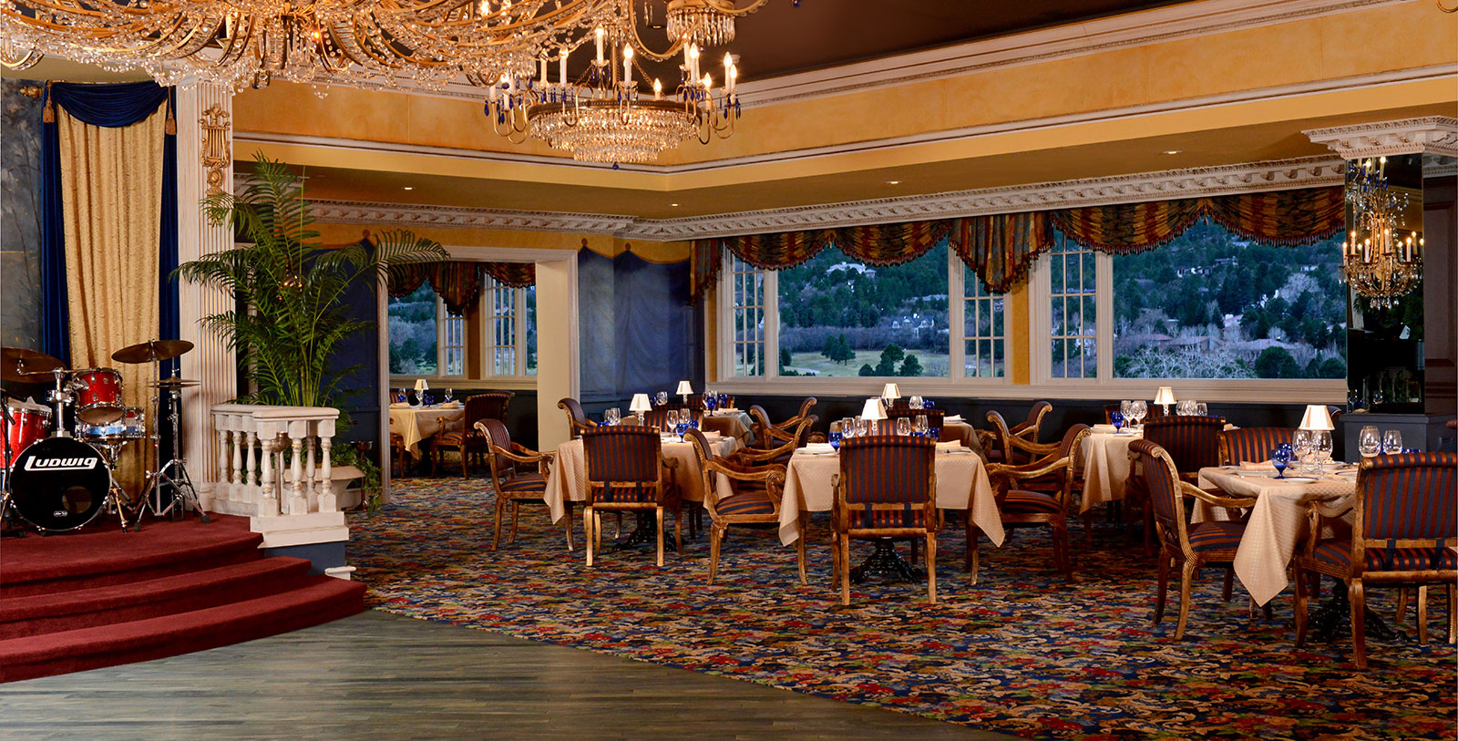 a room with a chandelier and tables