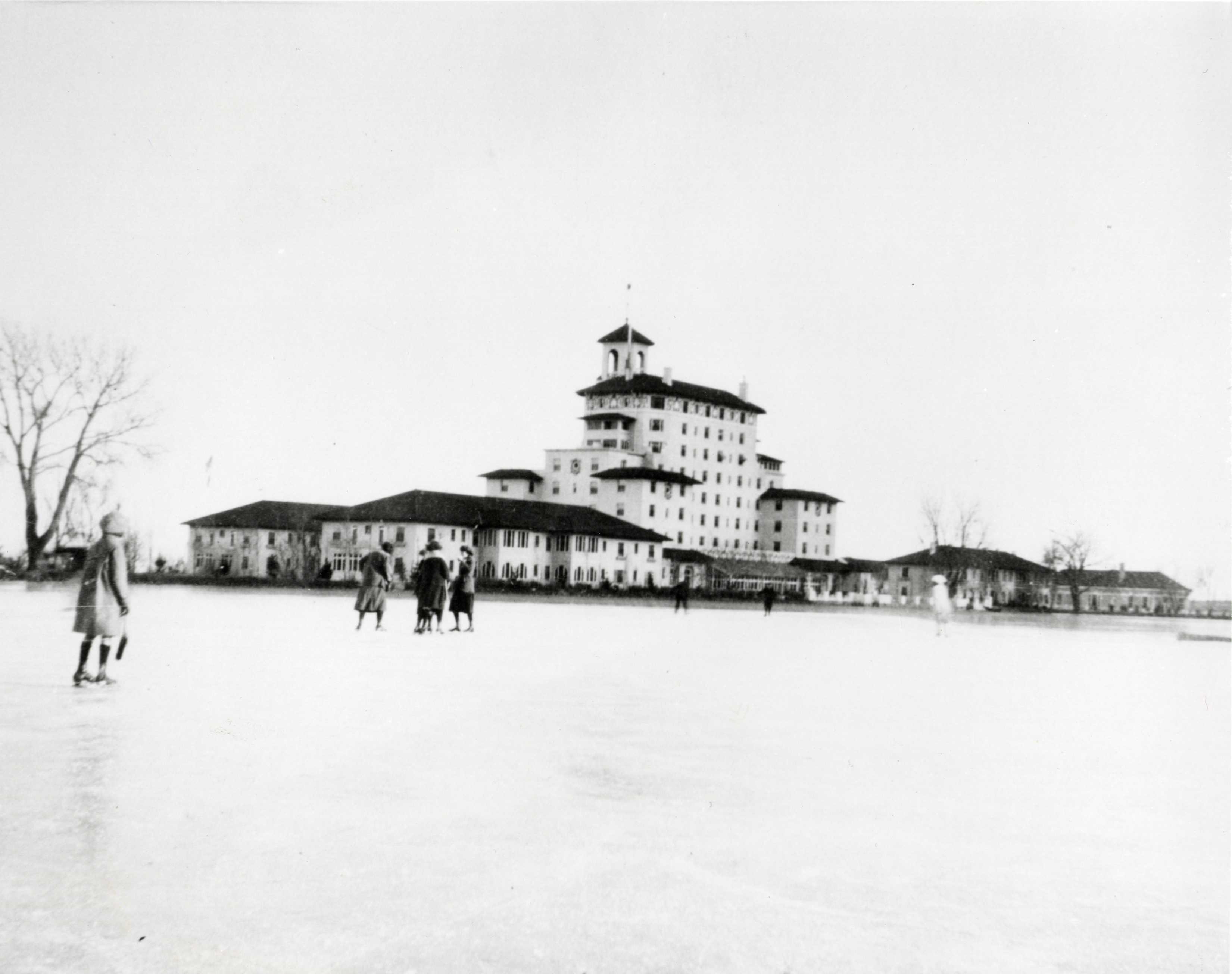 a group of people walking in front of a large building