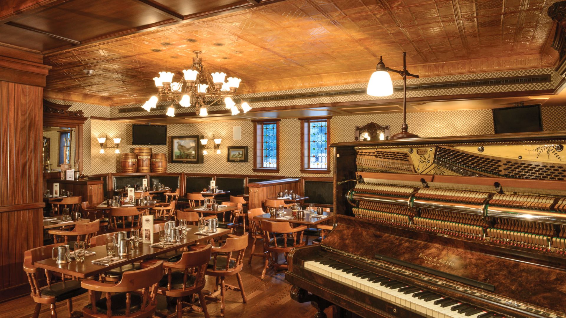 a room with a piano and tables