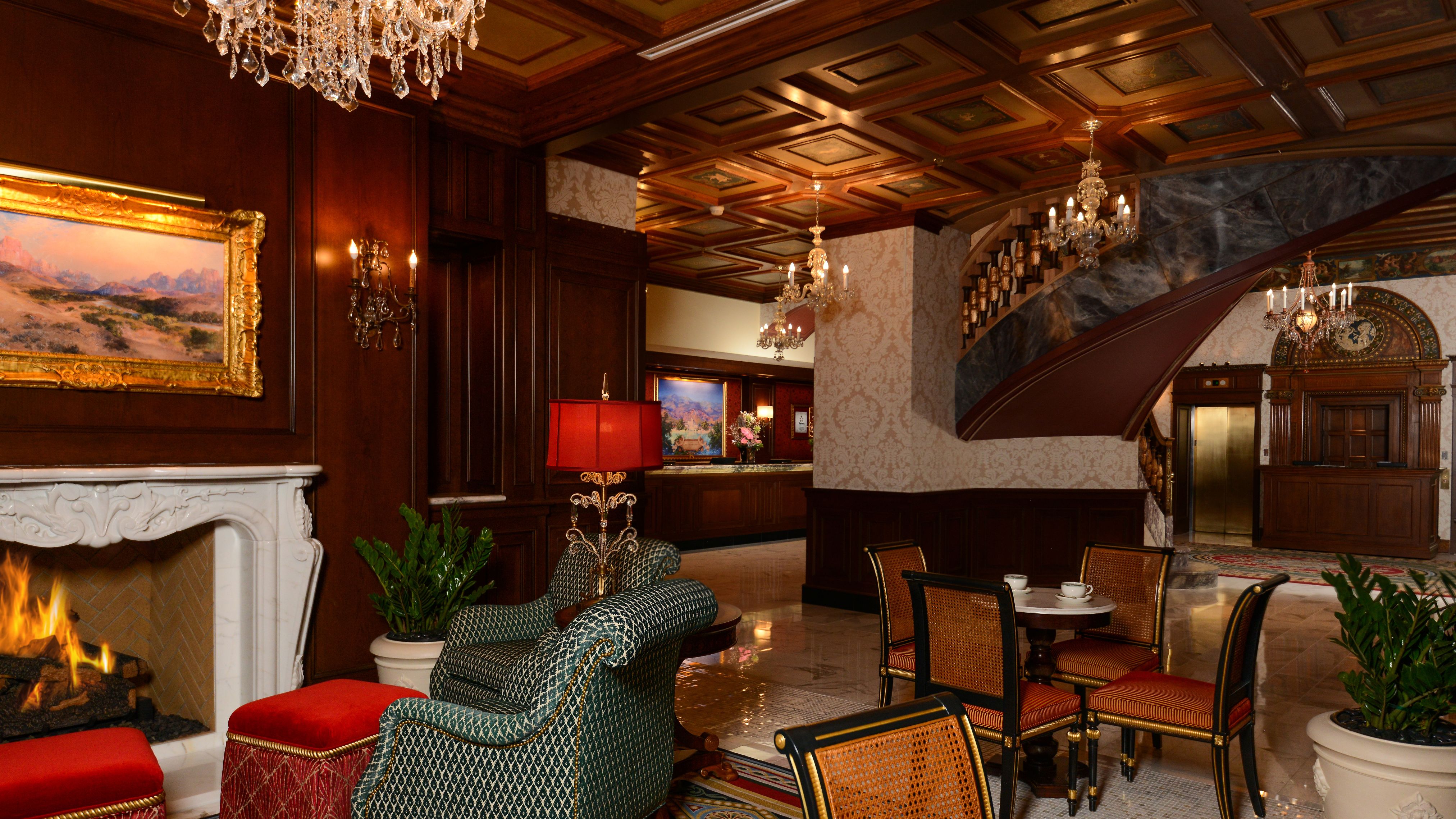 a room with chairs and chandeliers