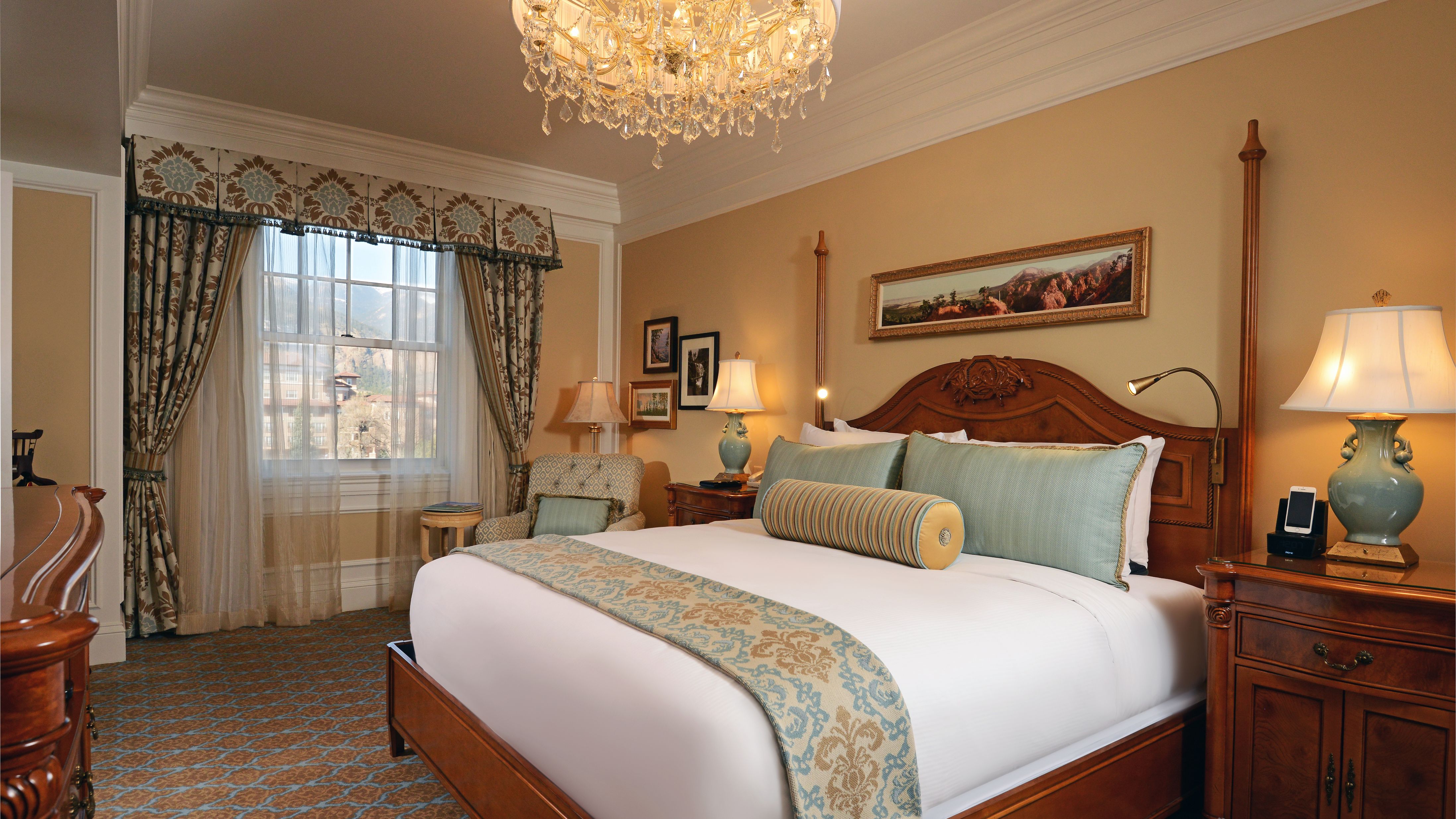 a bedroom with a bed and chandelier