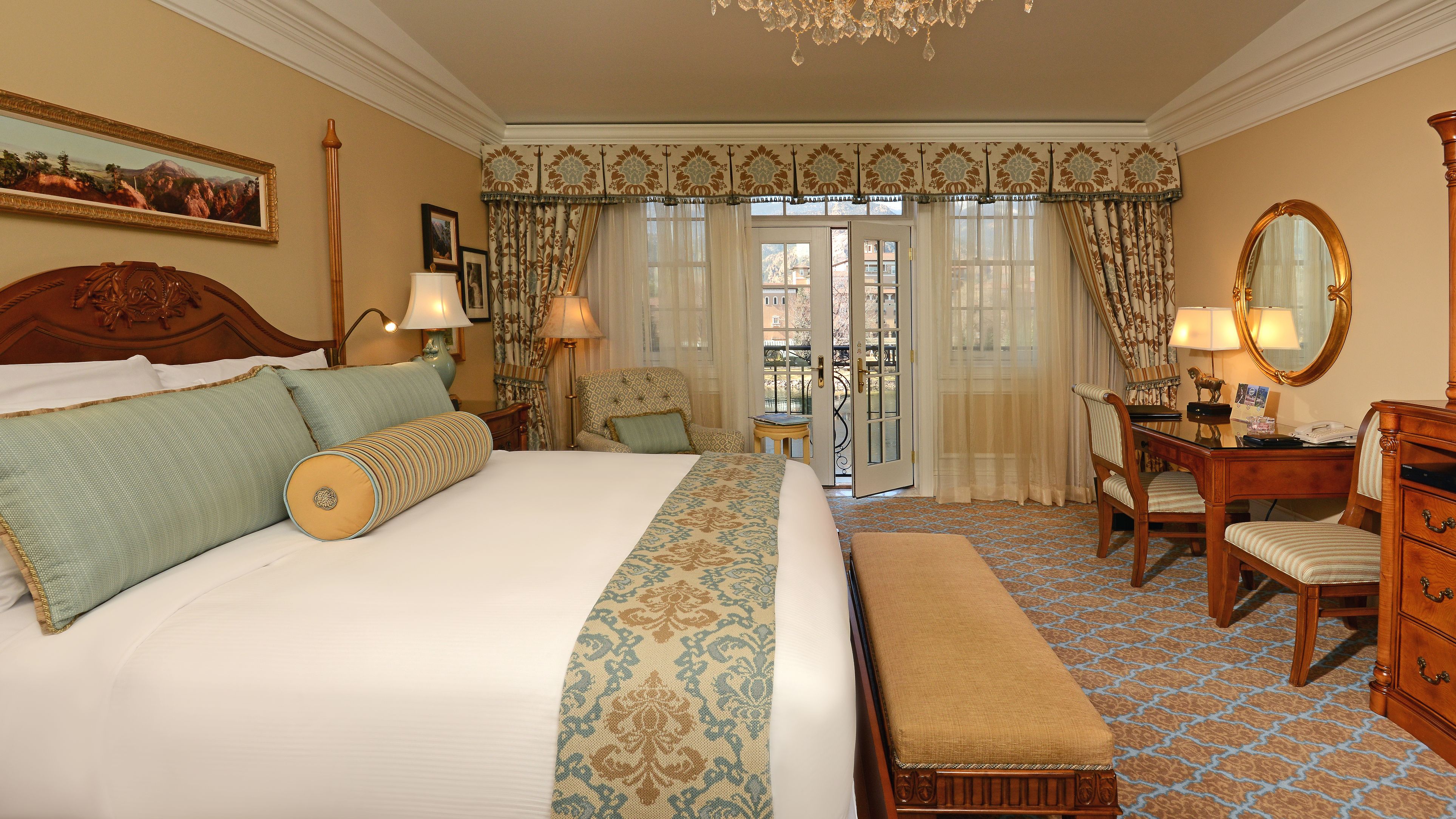 a room with a bed and a chandelier