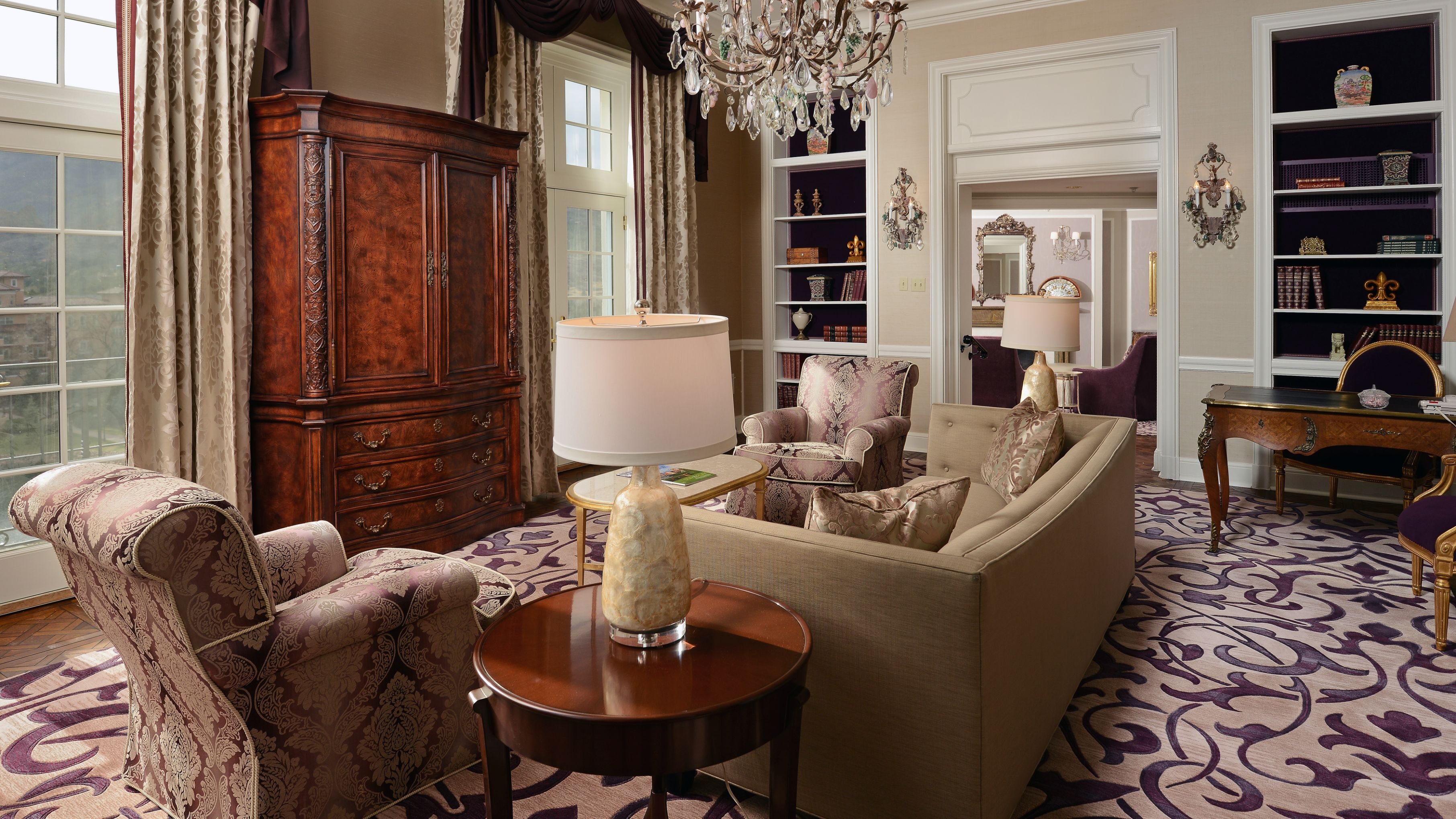 a living room with a chandelier and a lamp