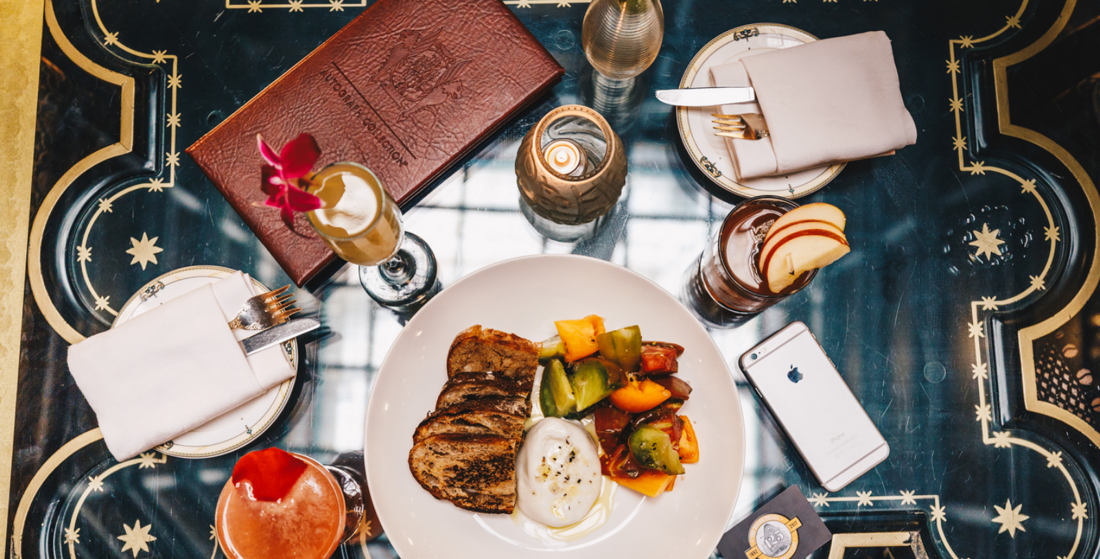 a plate of food and glasses of wine on a table