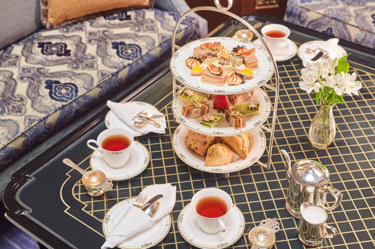 a tray of food and tea cups on a table