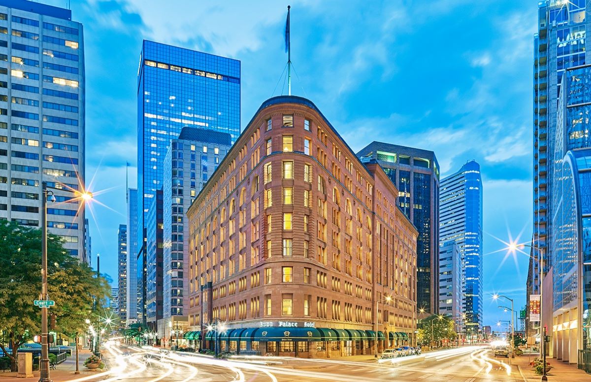 a city street with a building and skyscrapers