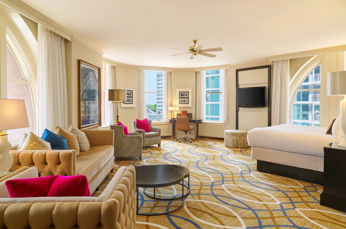 a room with a bed and couches