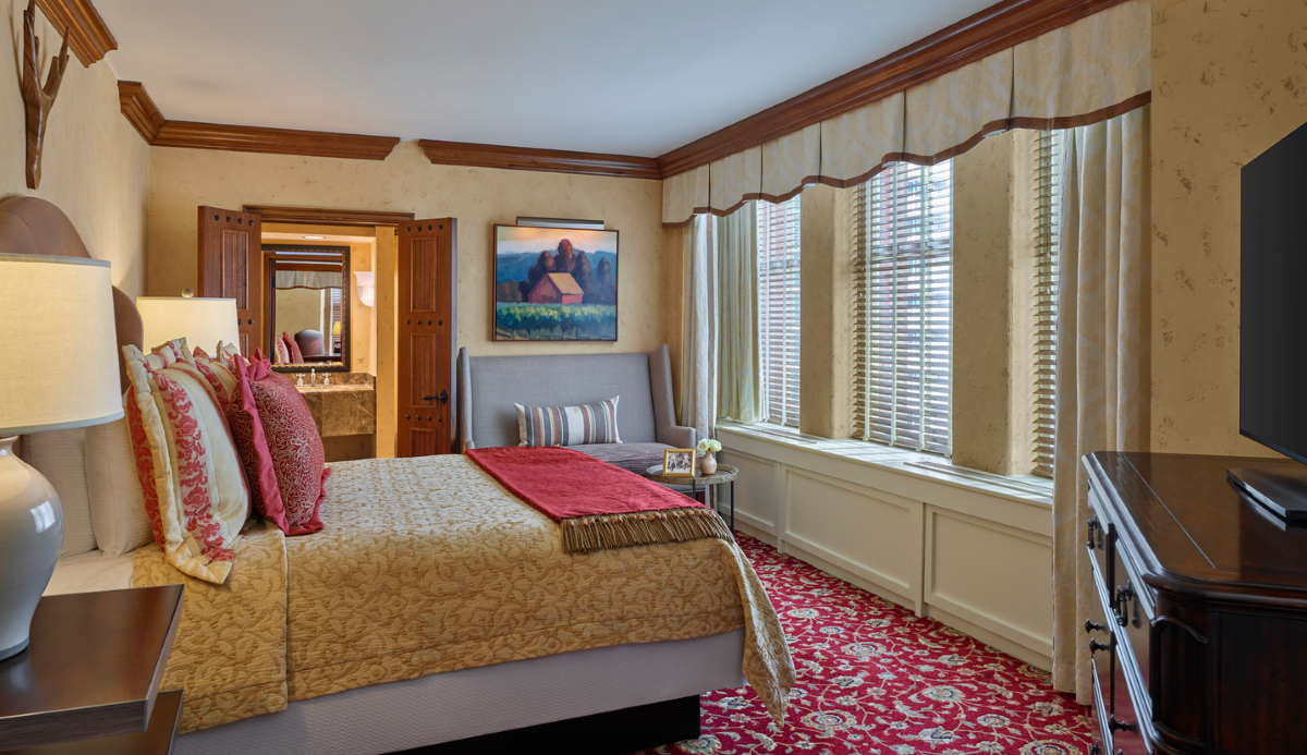 a bedroom with a bed and a mirror