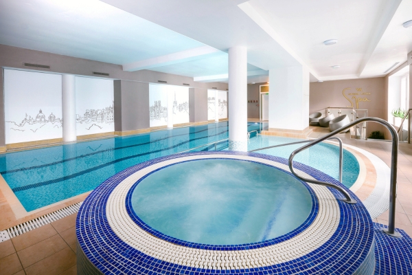 a swimming pool with a round jacuzzi