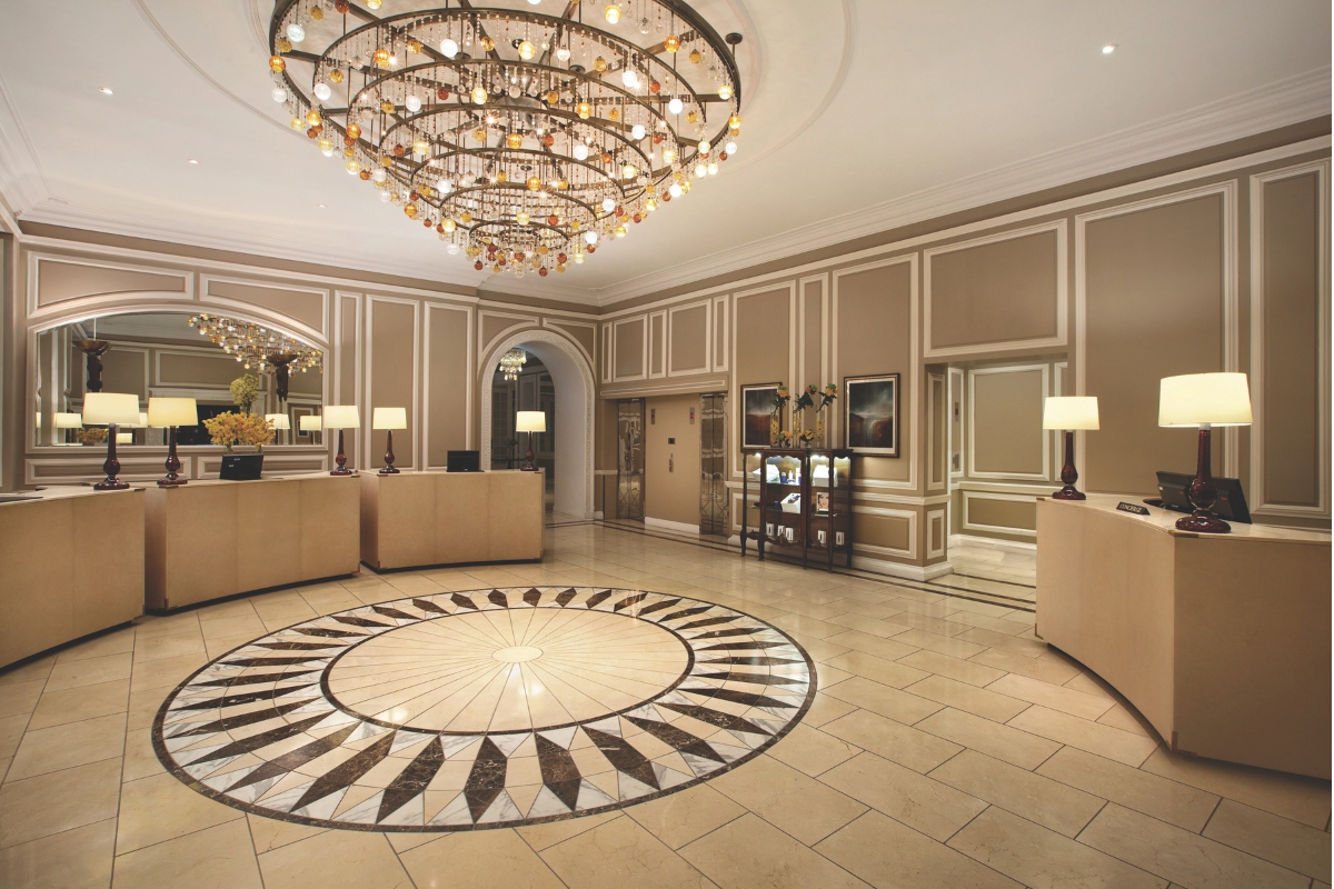 a lobby with a chandelier and a large round floor