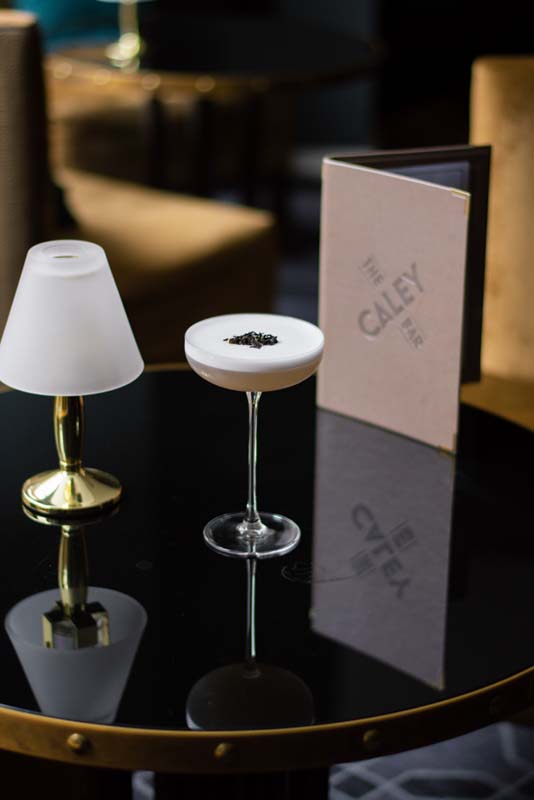 a glass with a drink on a table