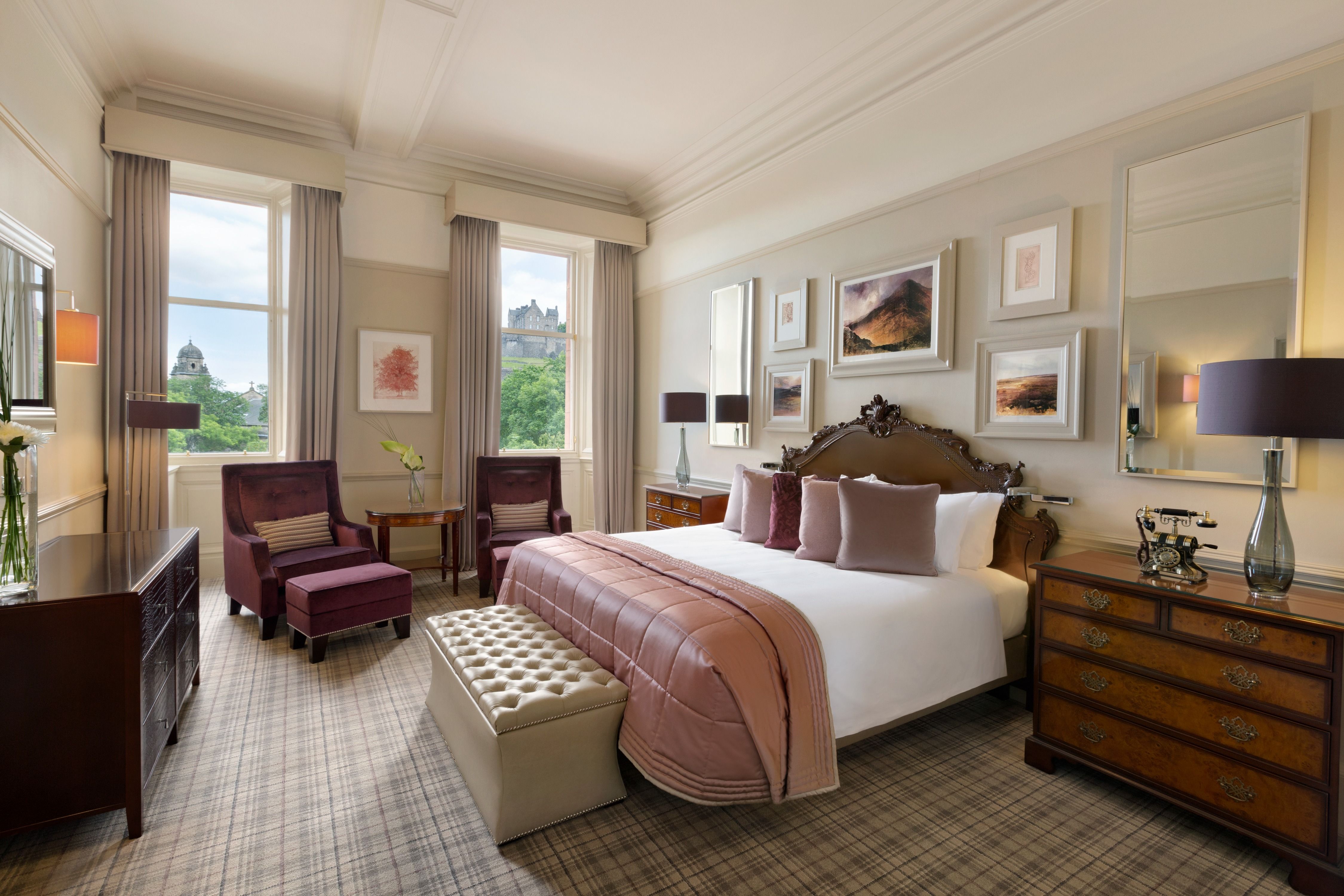 a bedroom with a bed and chairs