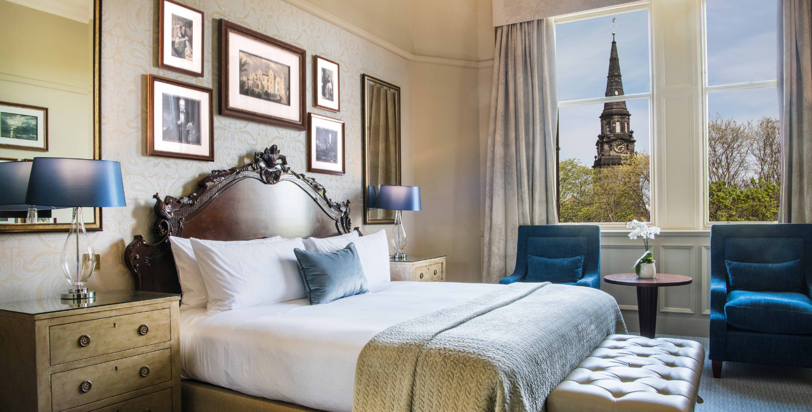 a bedroom with a large bed and a chair