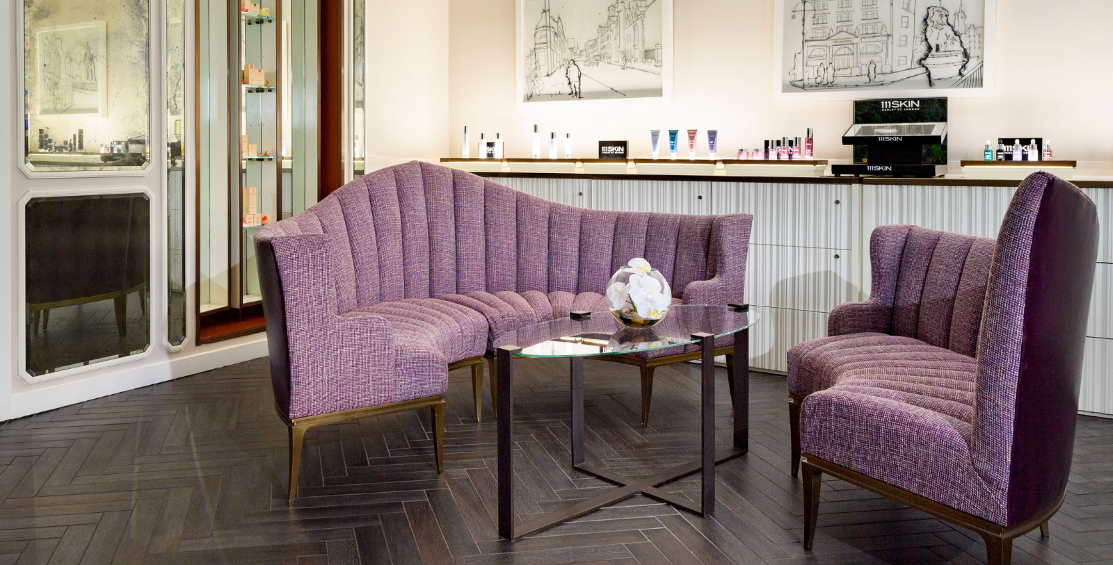 a purple couches and a glass table in a room