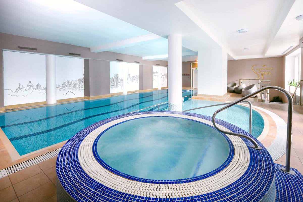 a swimming pool with a round jacuzzi