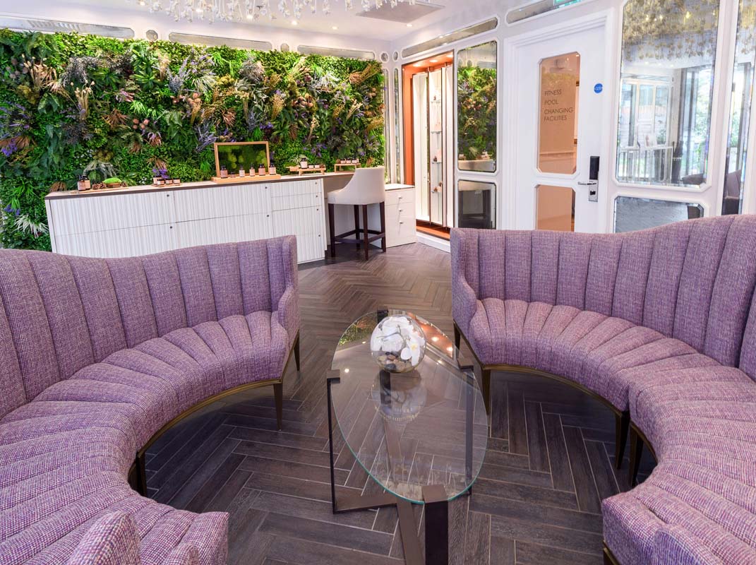 a room with purple chairs and a glass coffee table