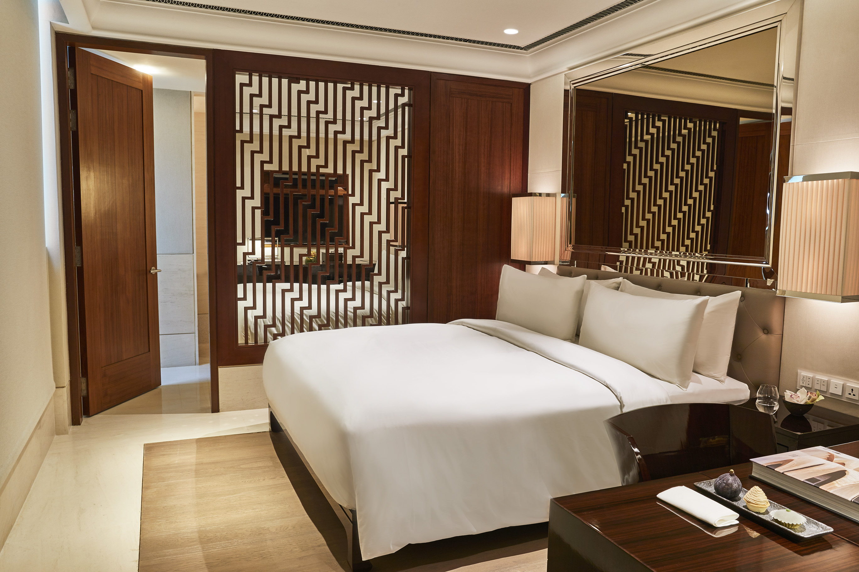 a bedroom with a large bed and a mirror