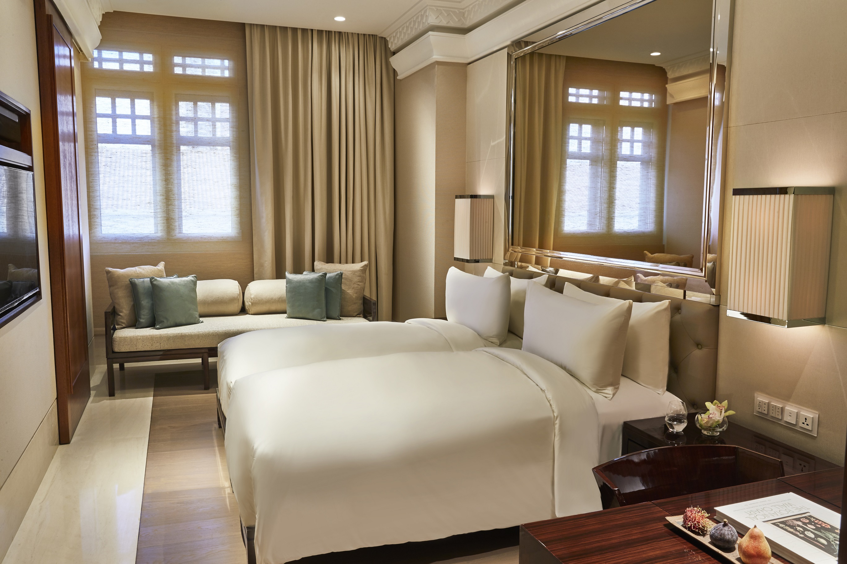 a room with two beds and a large mirror