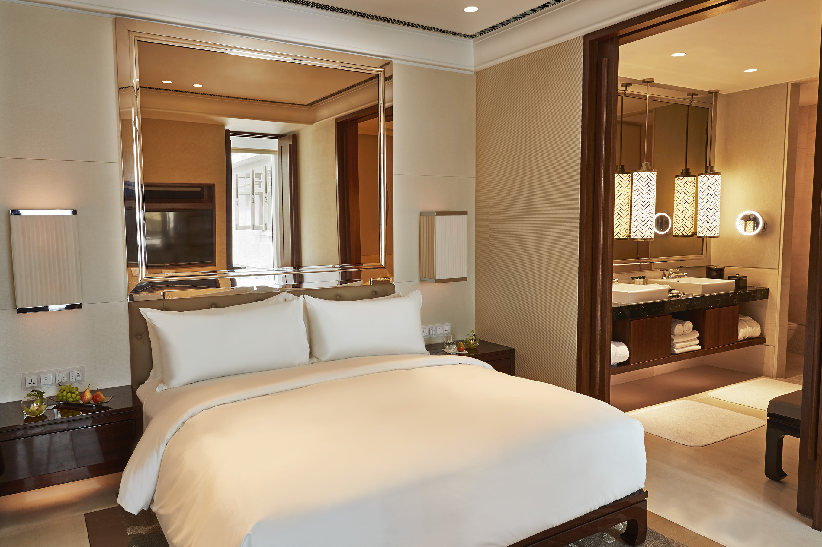 a bed with a mirror above it