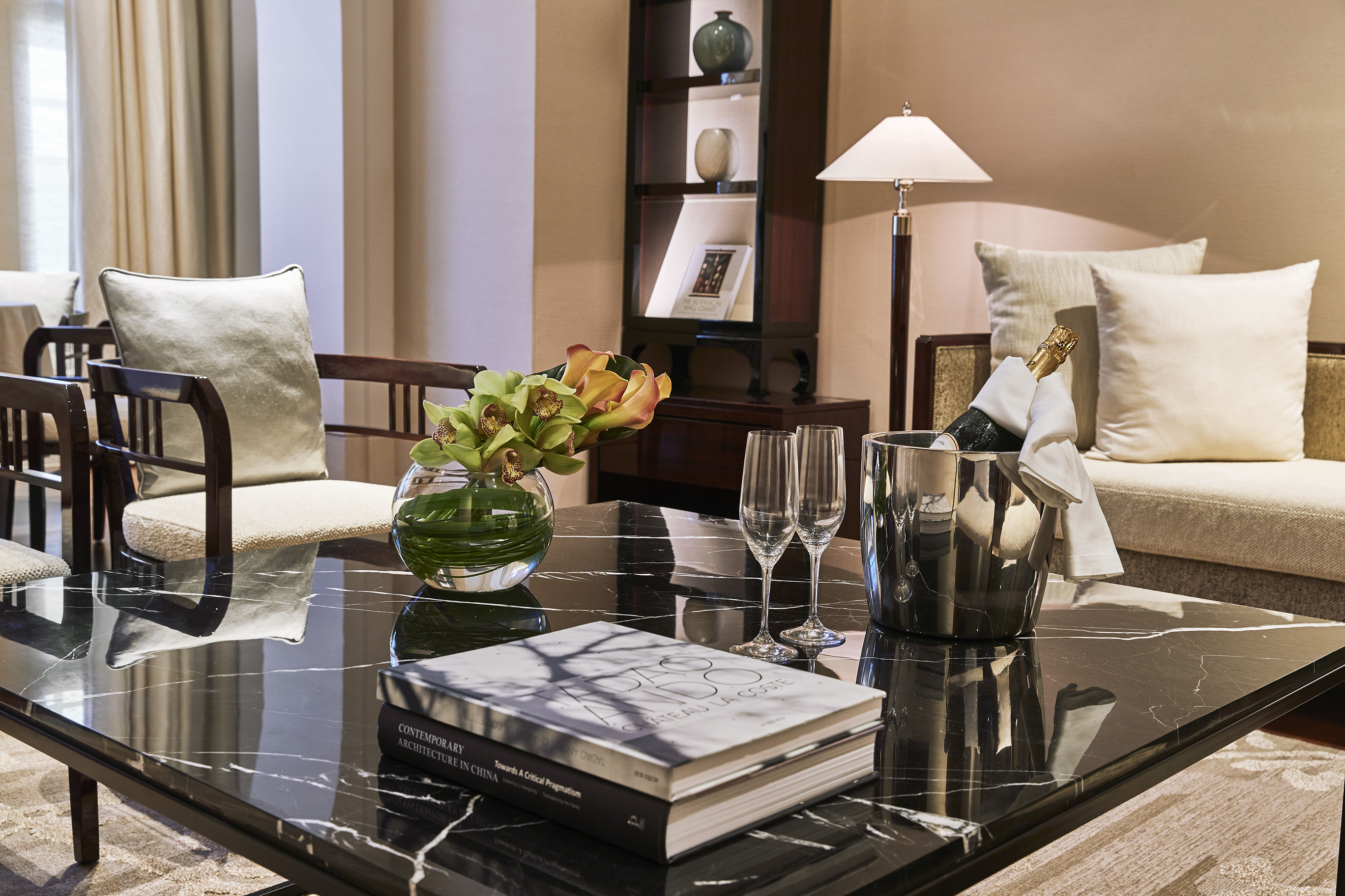 a table with a book and wine glasses in a room
