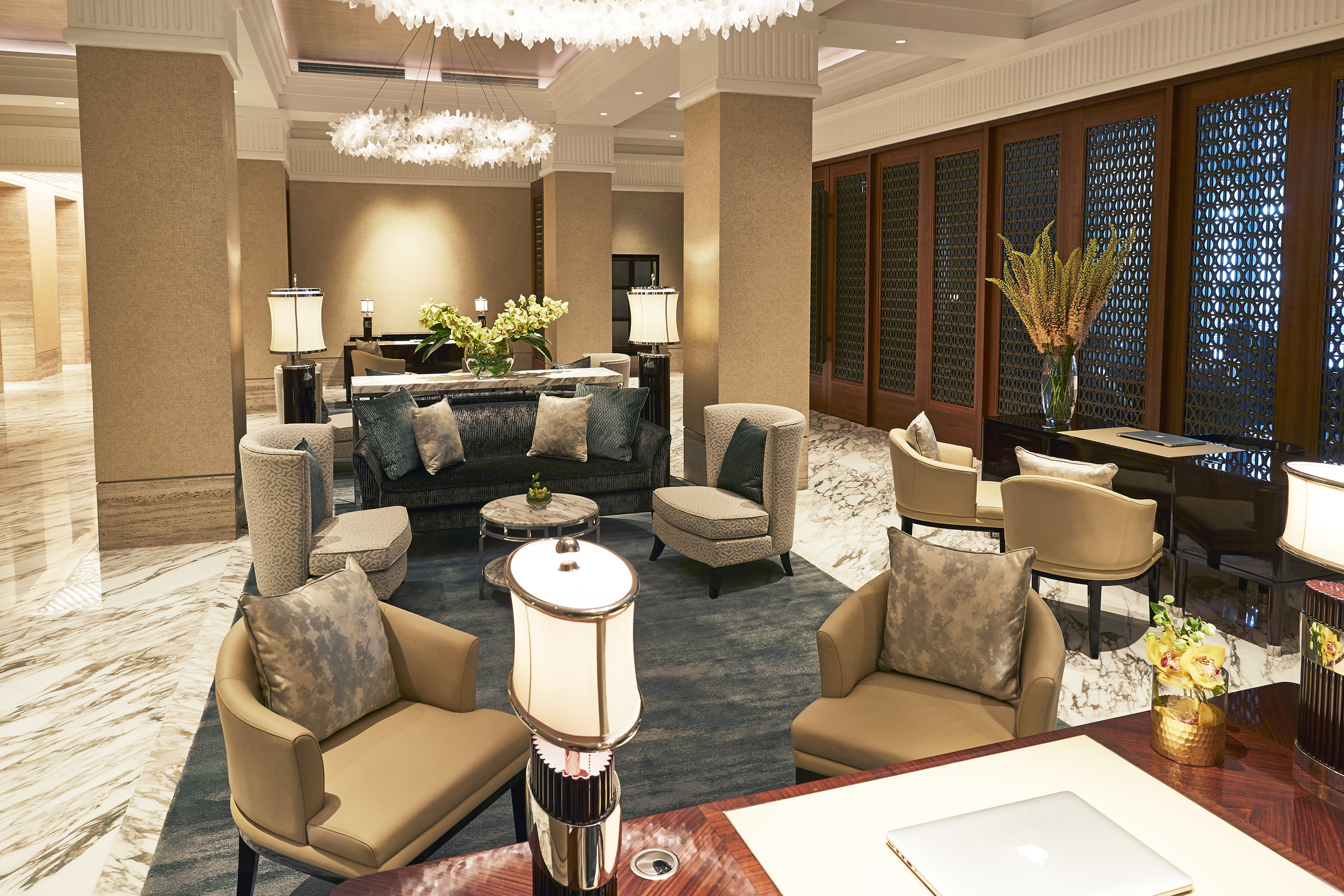 a room with a large chandelier and chairs