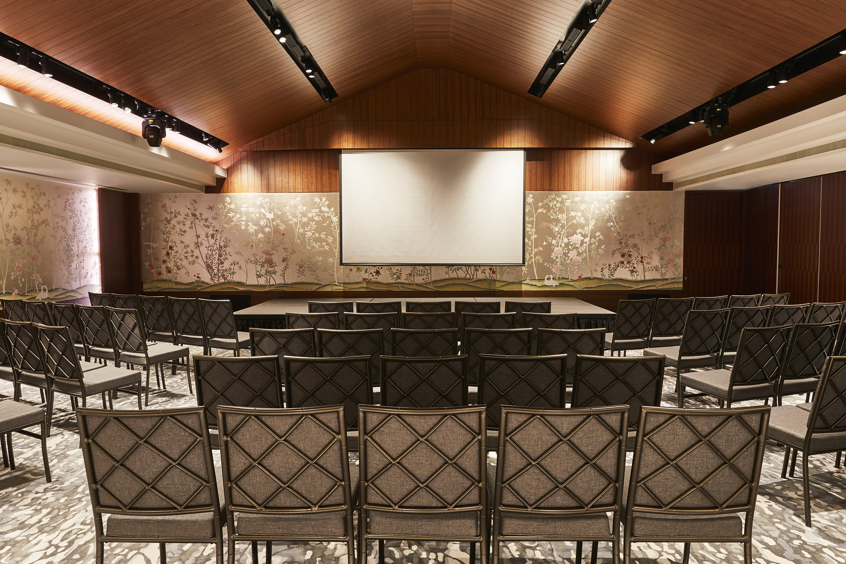 a room with chairs and a projector screen