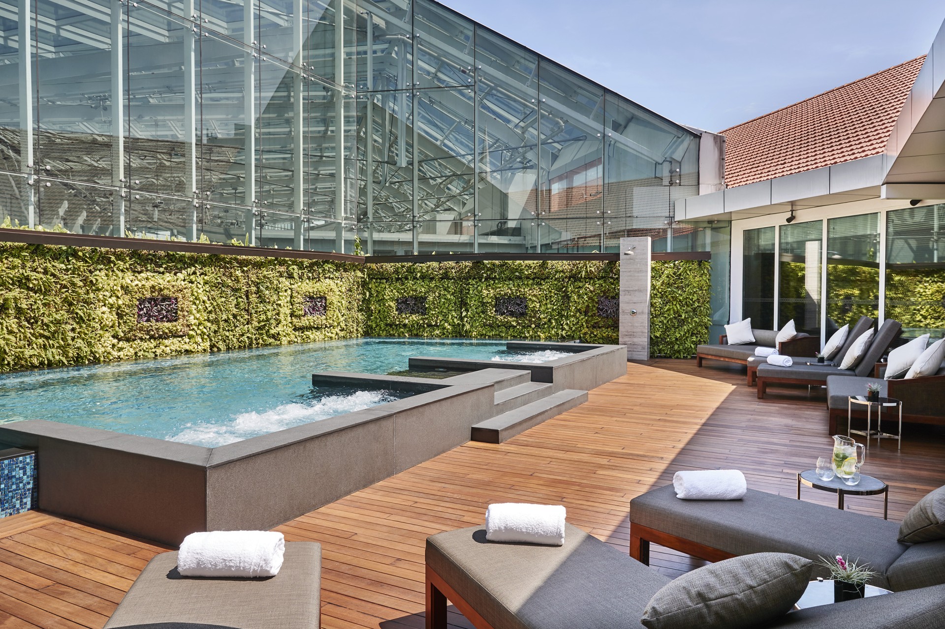 a pool with a glass wall and a glass wall