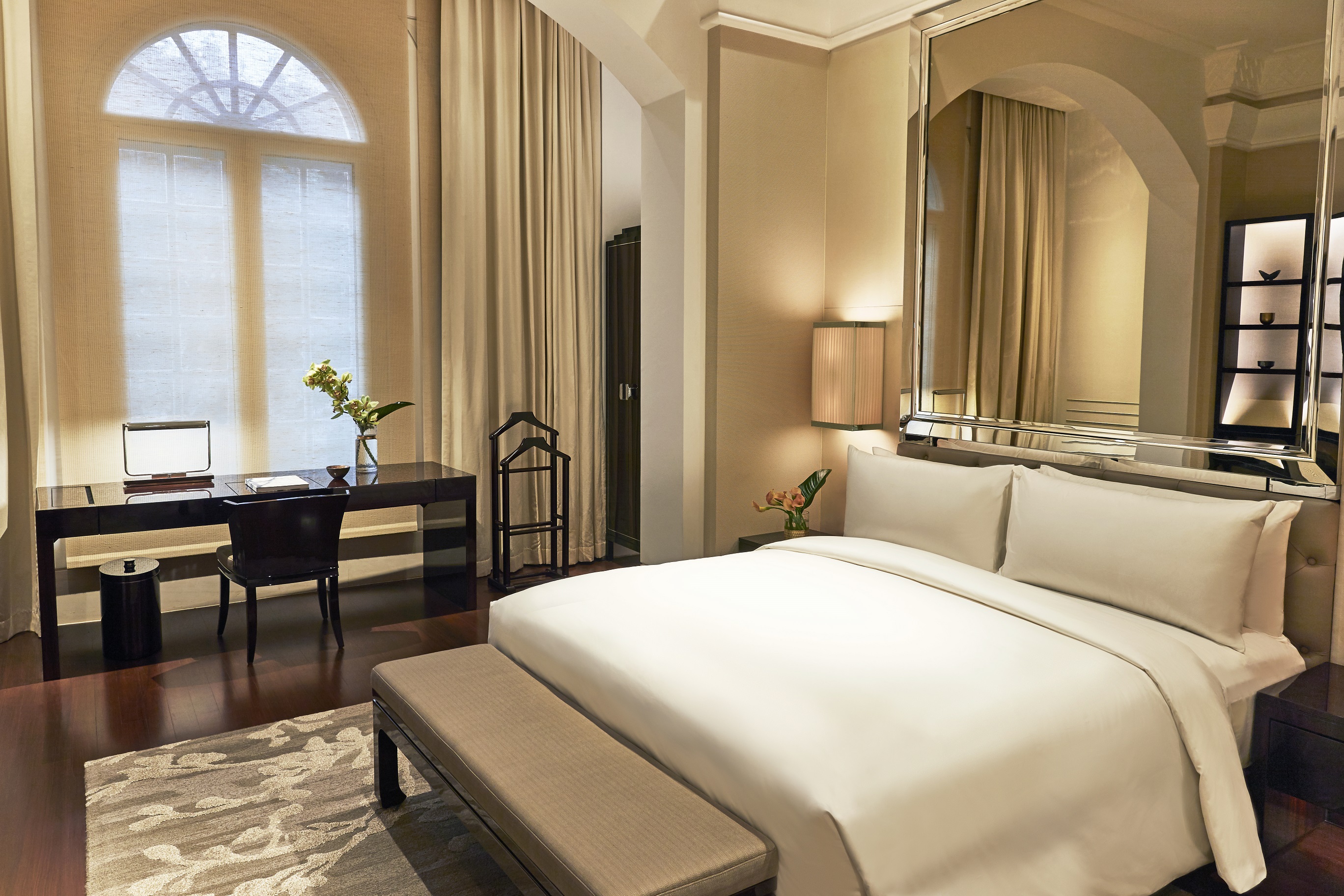 a bedroom with a large mirror and a bed