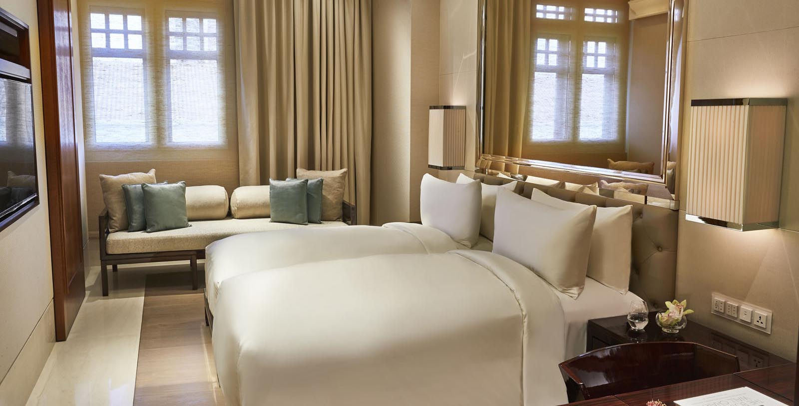 a room with two beds and a mirror
