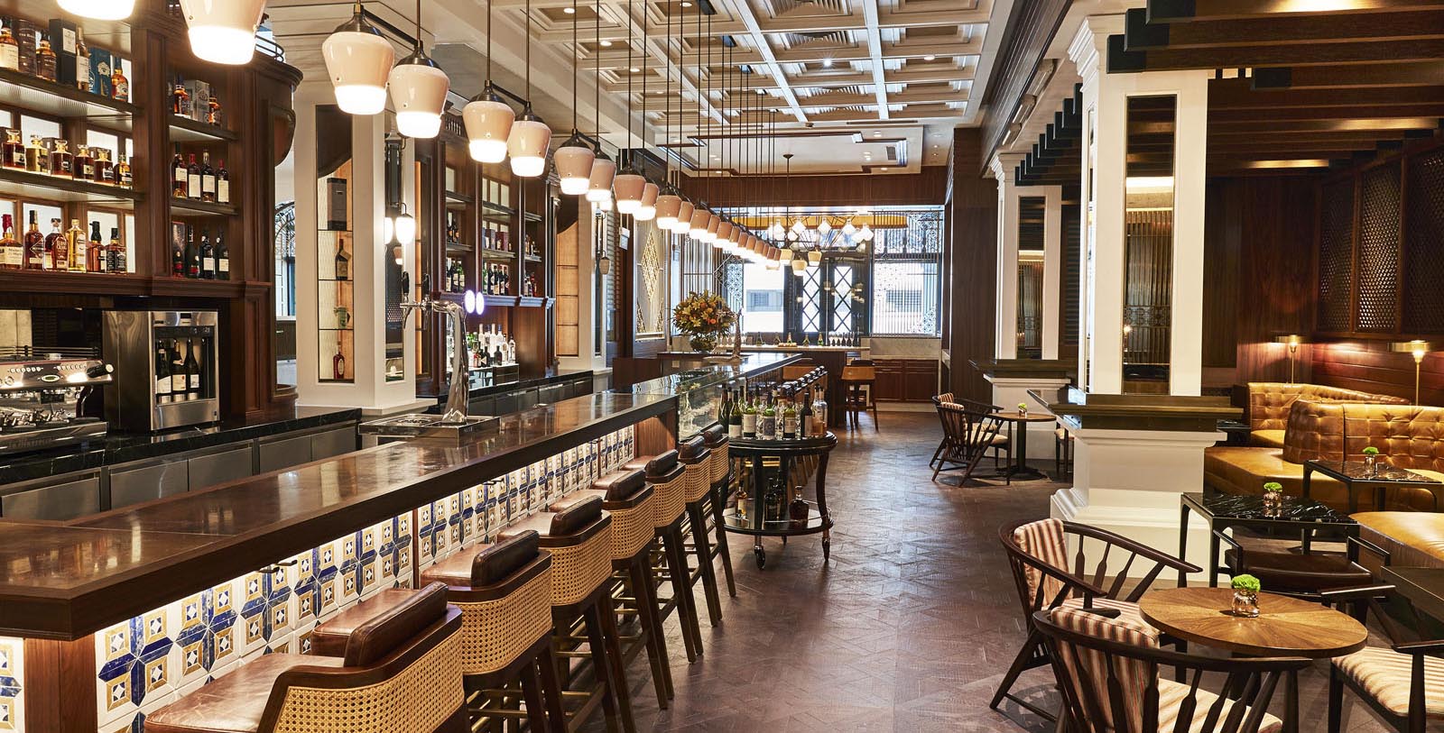 a bar with chairs and a row of lights