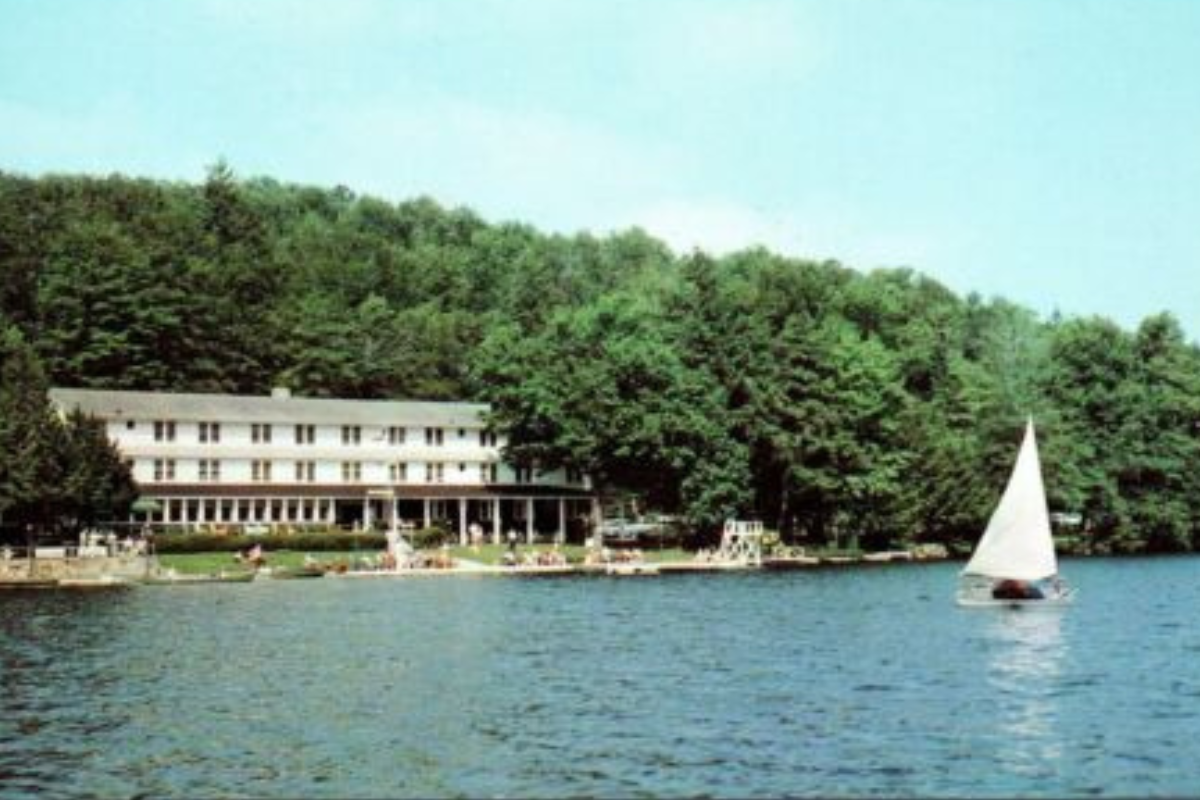 a white building next to a lake