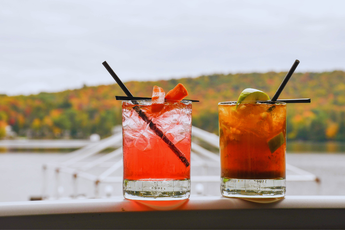 two glasses of drinks on a ledge