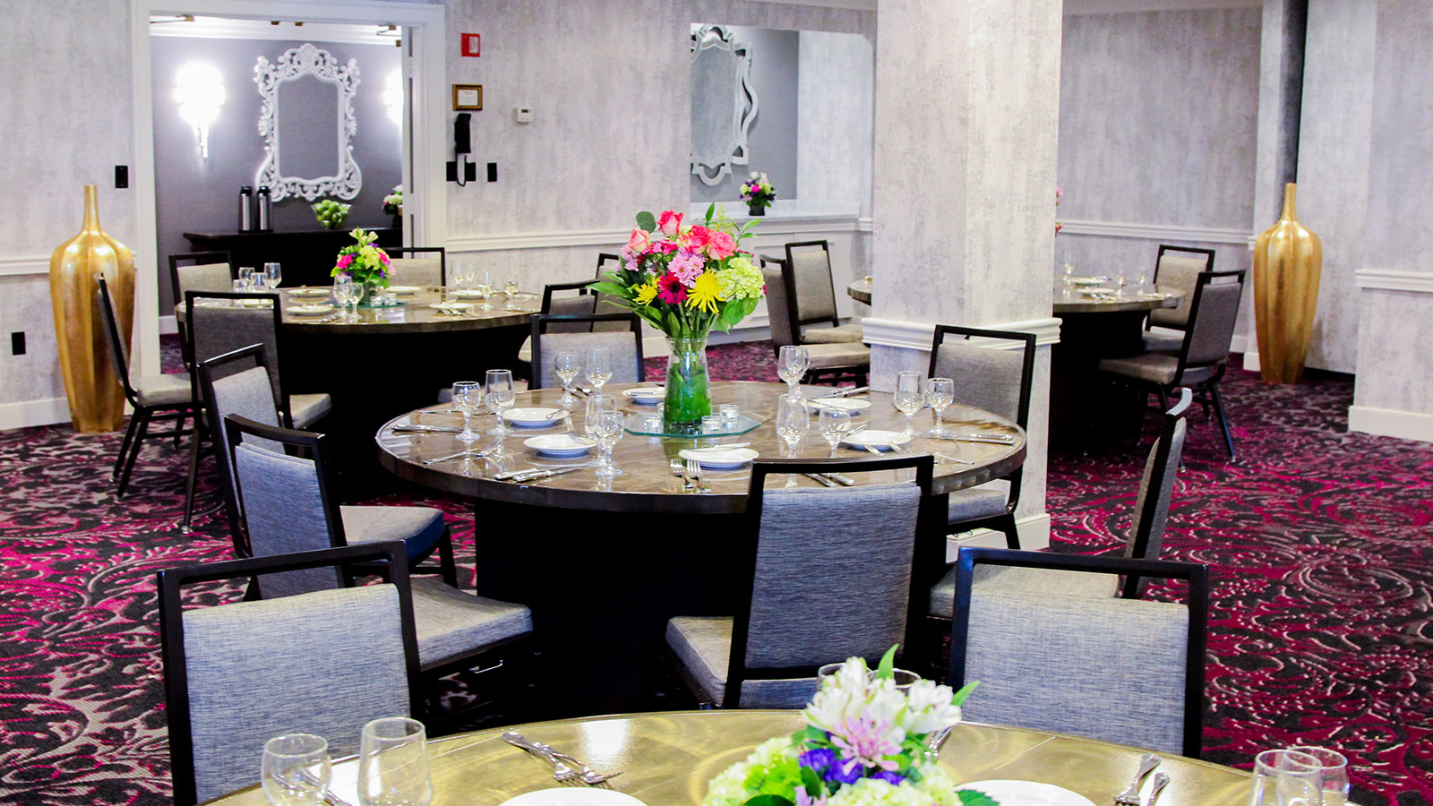 a group of tables with chairs and flowers