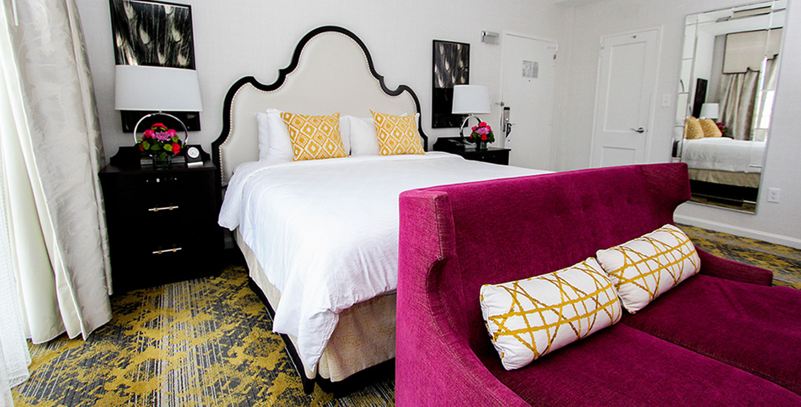 a bed with a pink couch and a white bed