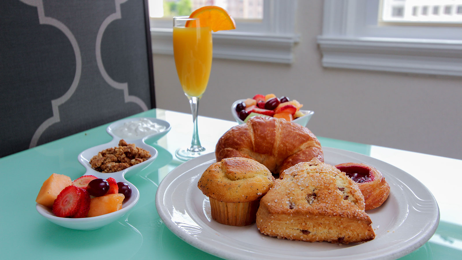 a plate of food and a glass of orange juice