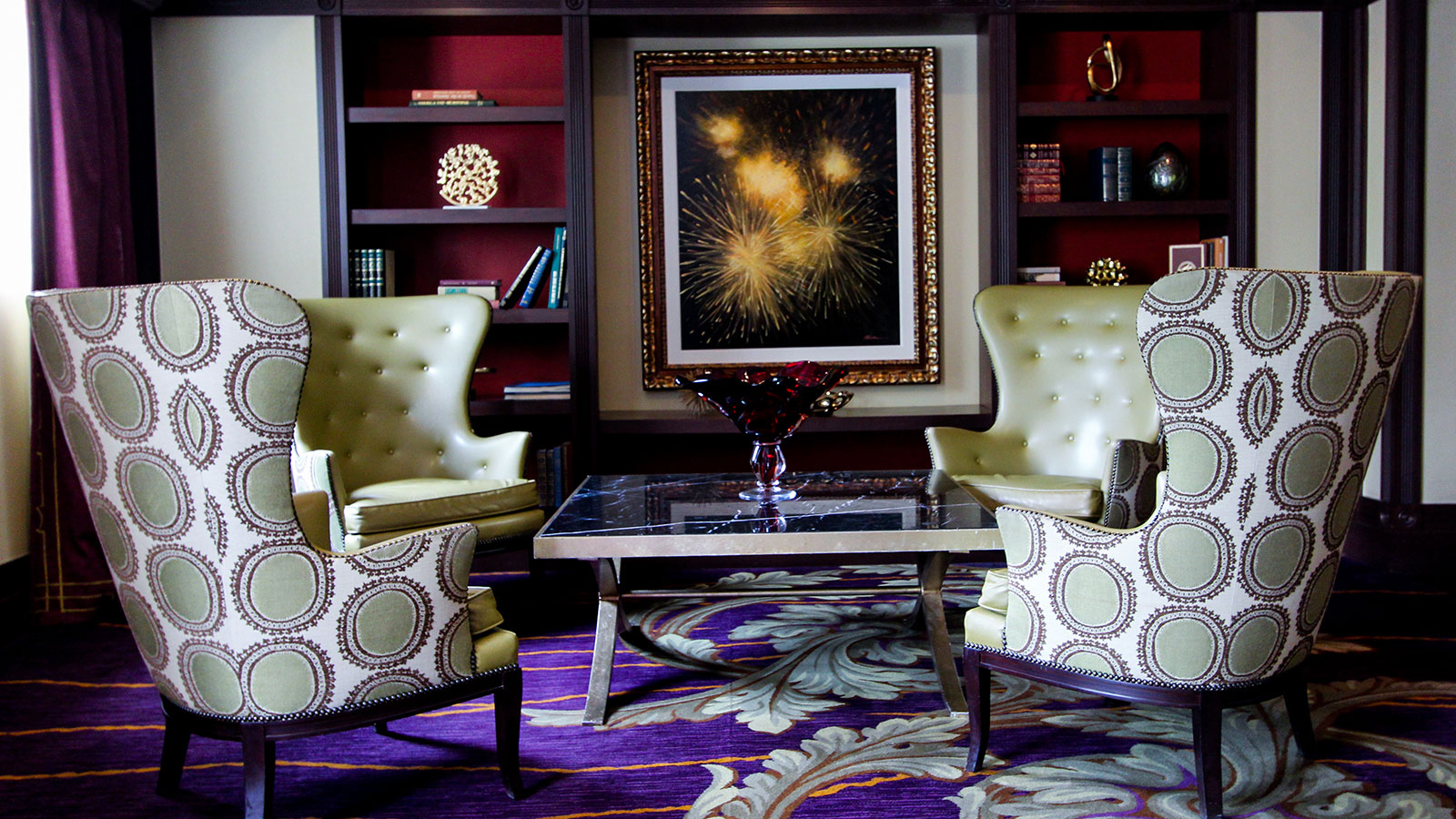 a room with a painting and chairs