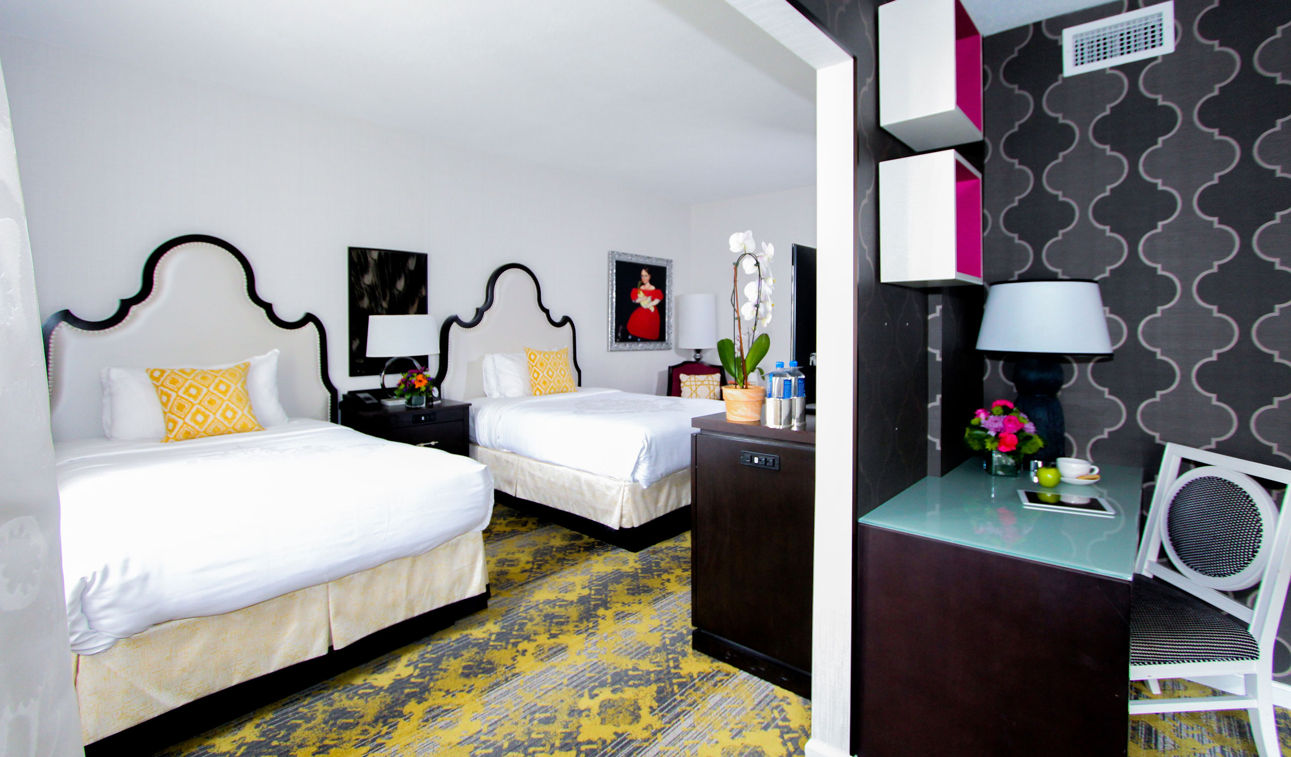 a room with two beds and a table