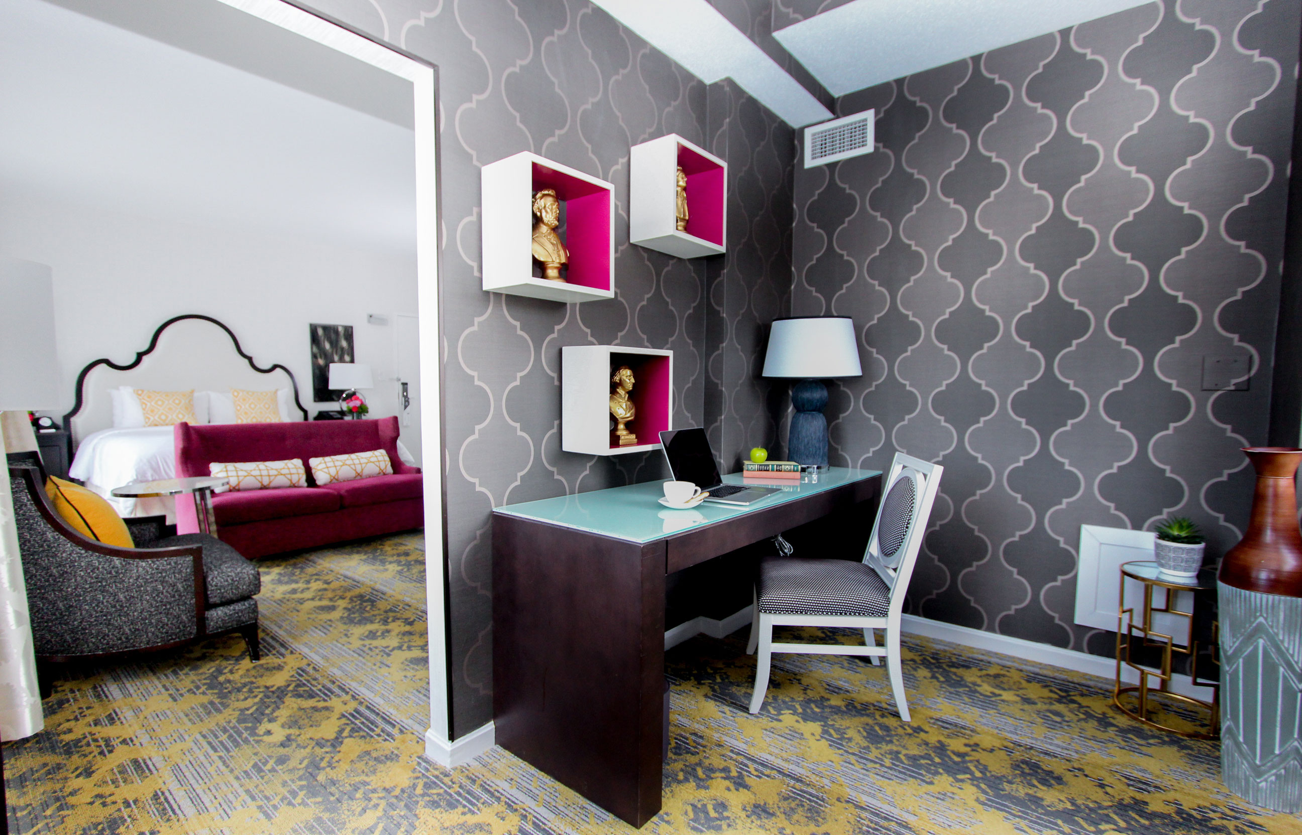 a desk with a chair and a lamp in a room