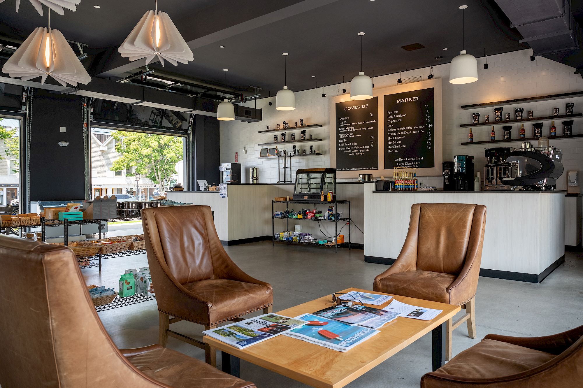 a coffee shop with leather chairs and a table
