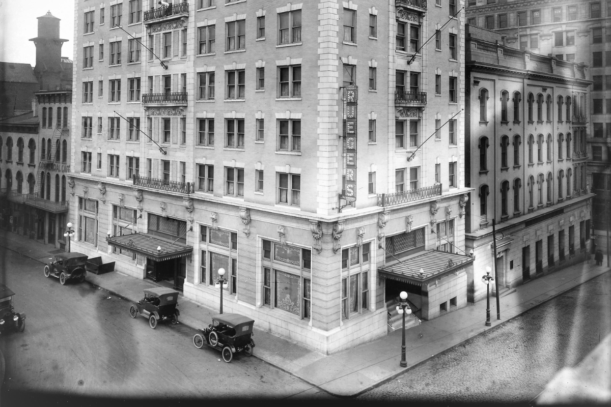 an old building with cars parked on the side of it