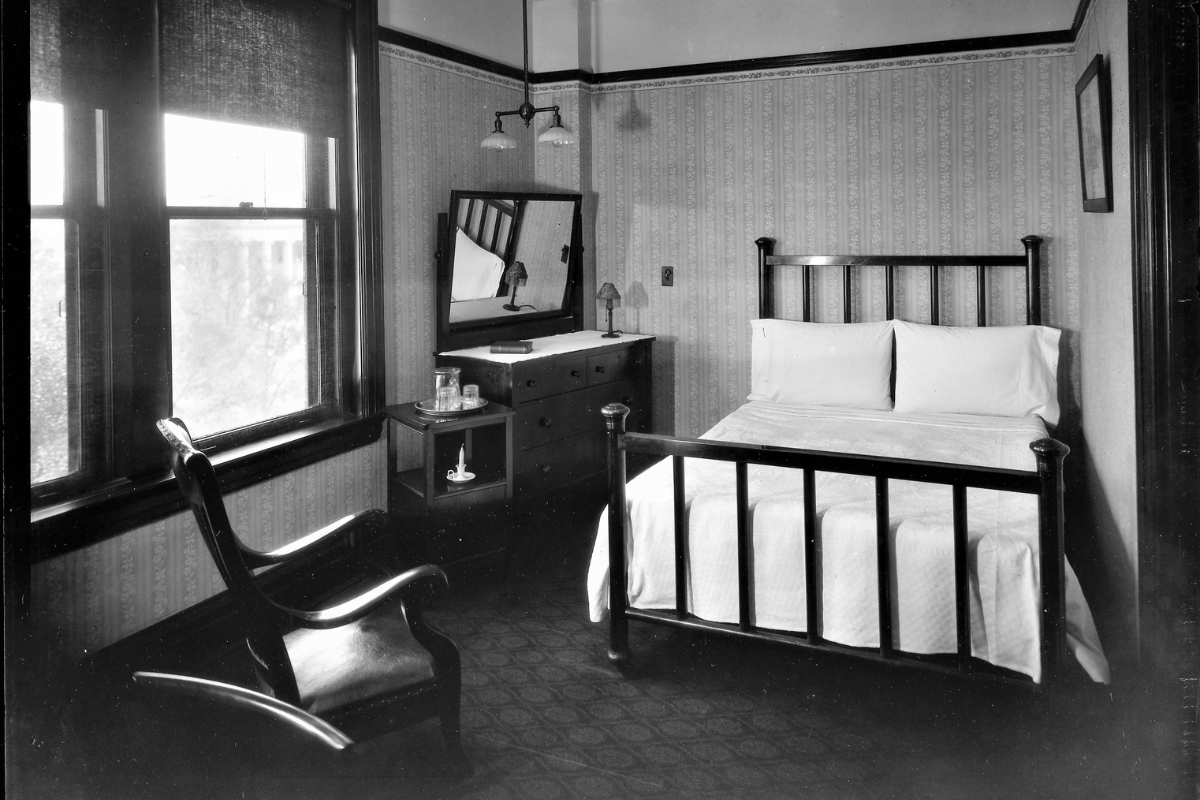 a bedroom with a mirror and a bed