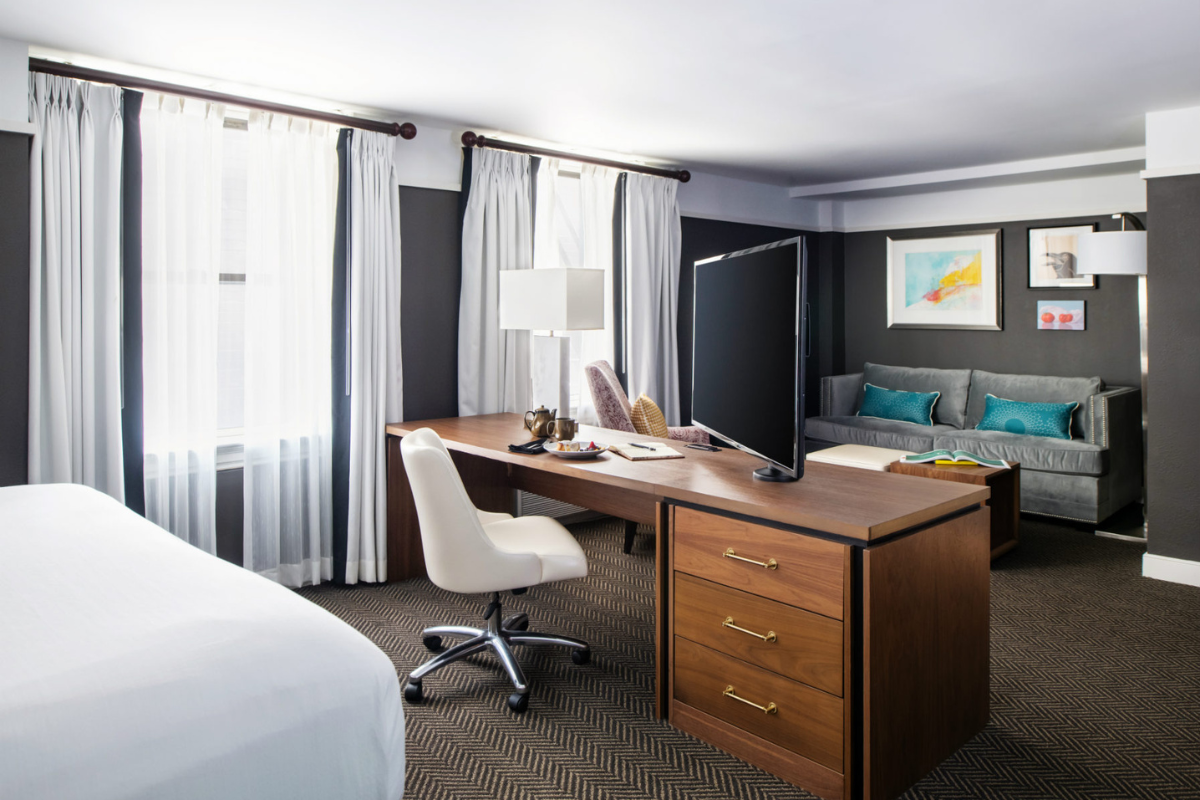 a room with a desk and a bed