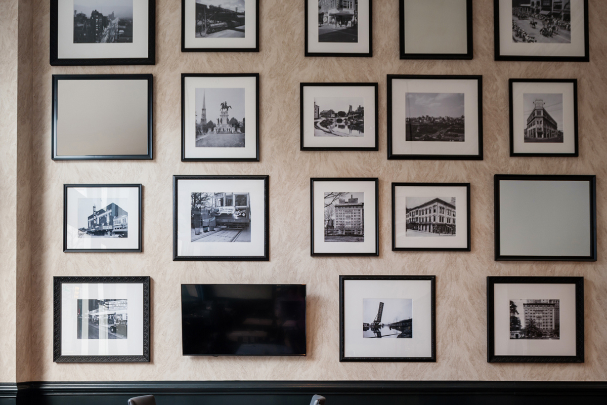 a wall with pictures of different cities