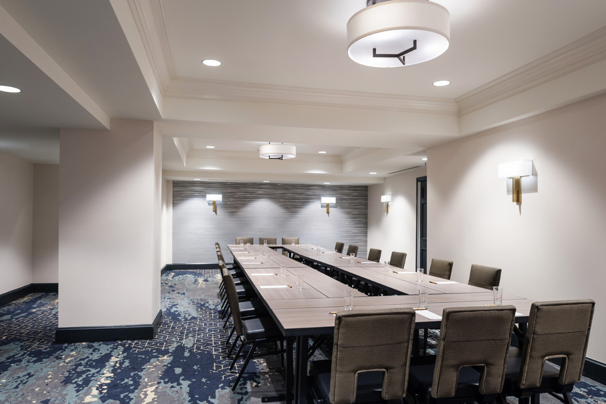 a room with a long table and chairs
