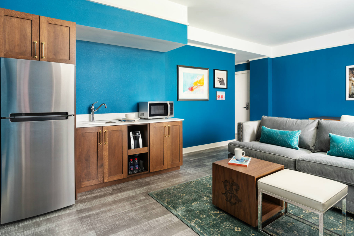 a room with a couch and a microwave in it