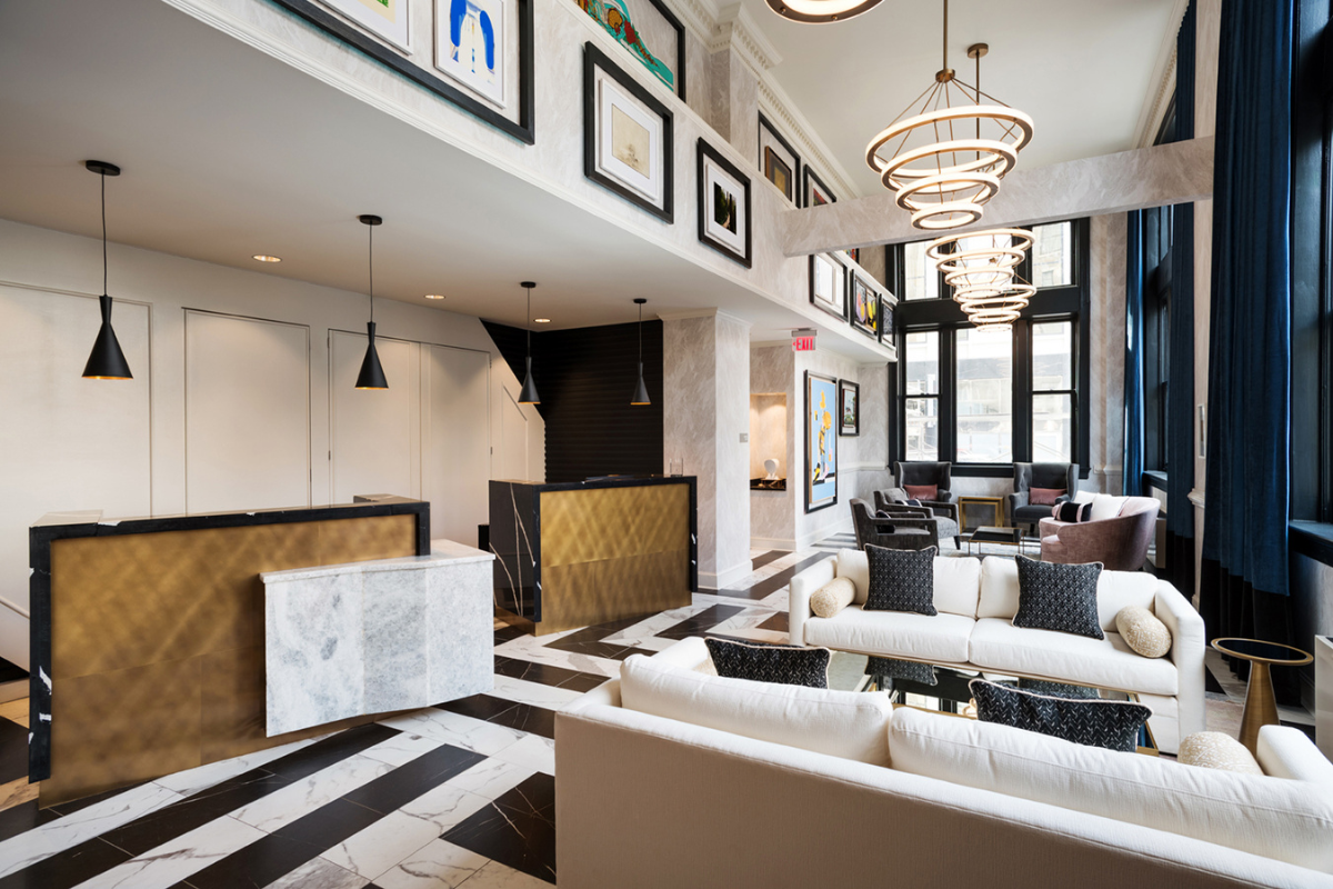 a lobby with a reception desk and art on the wall