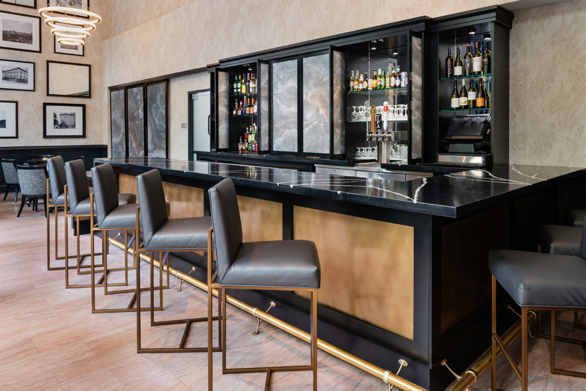 a bar with a counter and chairs