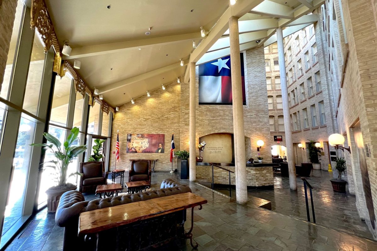 a lobby with a large brick building and a flag on the wall