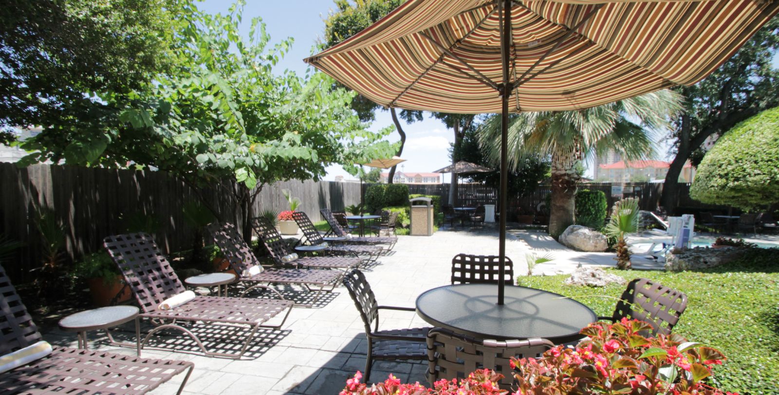 a patio with chairs and umbrellas