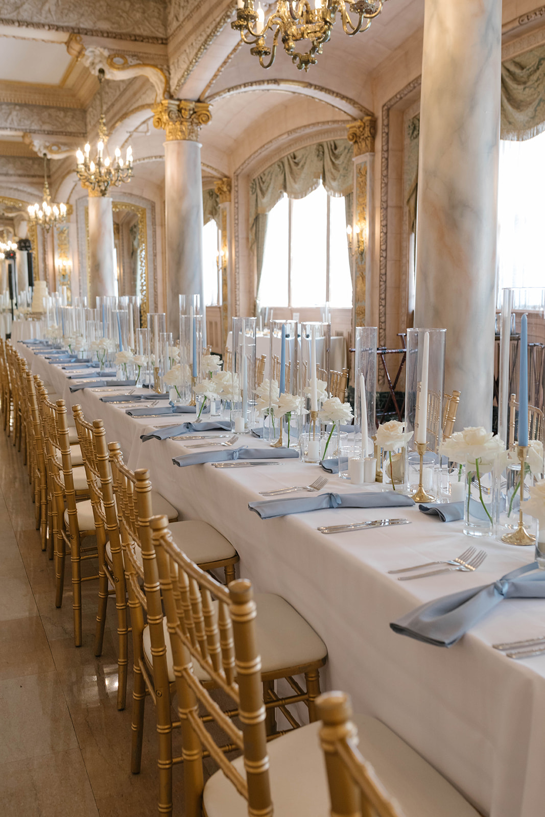 a long table with white flowers and candles